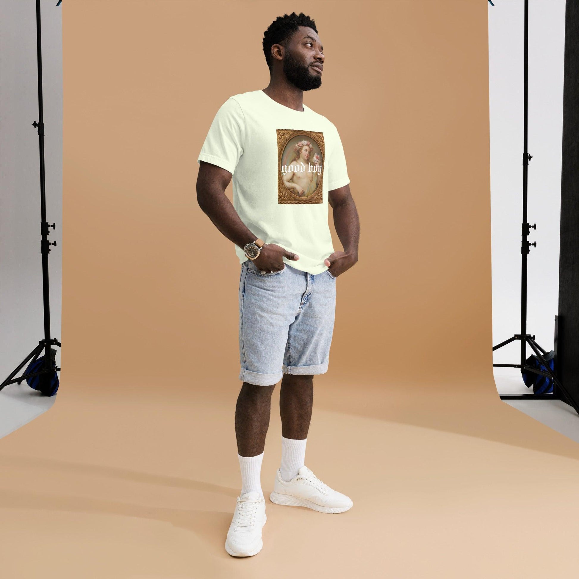 Man wearing a good boy graphic organic tee from The Siq Collective paired with light denim shorts and white sneakers