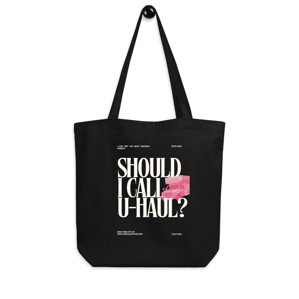 Black tote bag with white text and pink truck graphic featuring Should I Call UHaul Organic Tote design